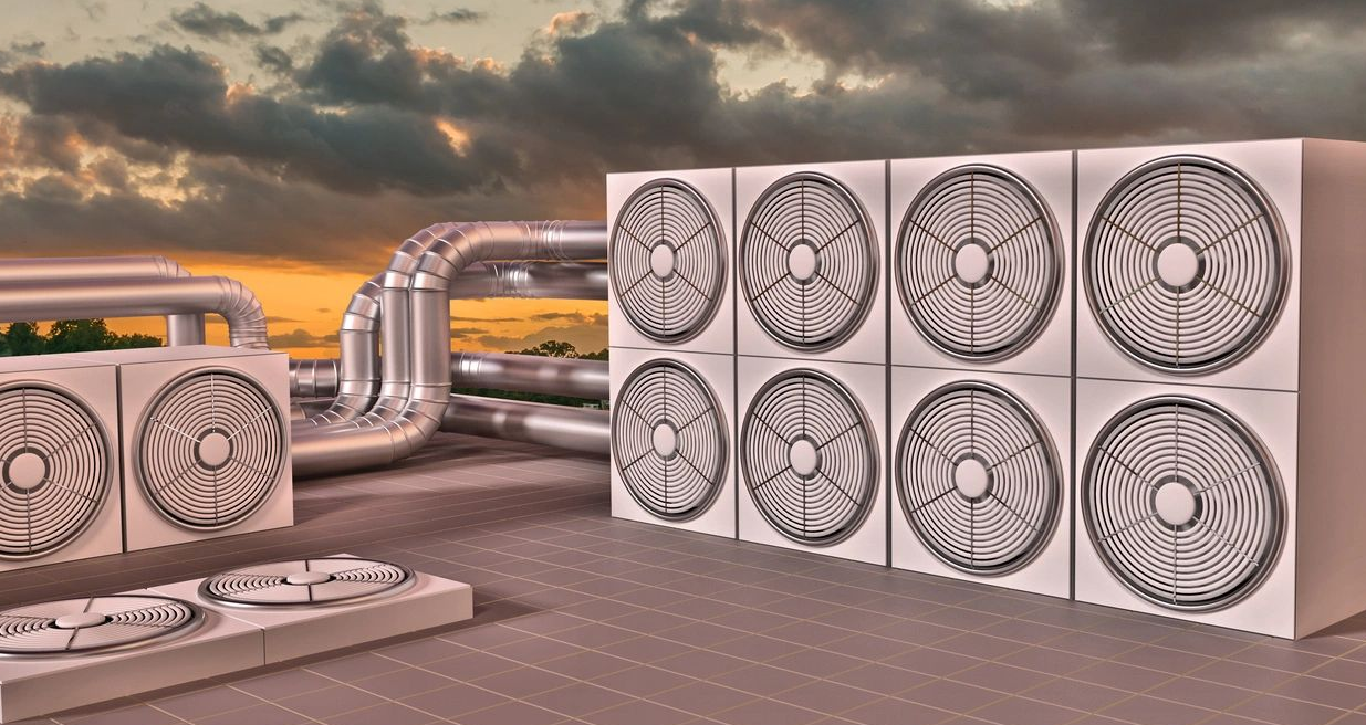 Rooftop HVAC fans and ductwork at sunset