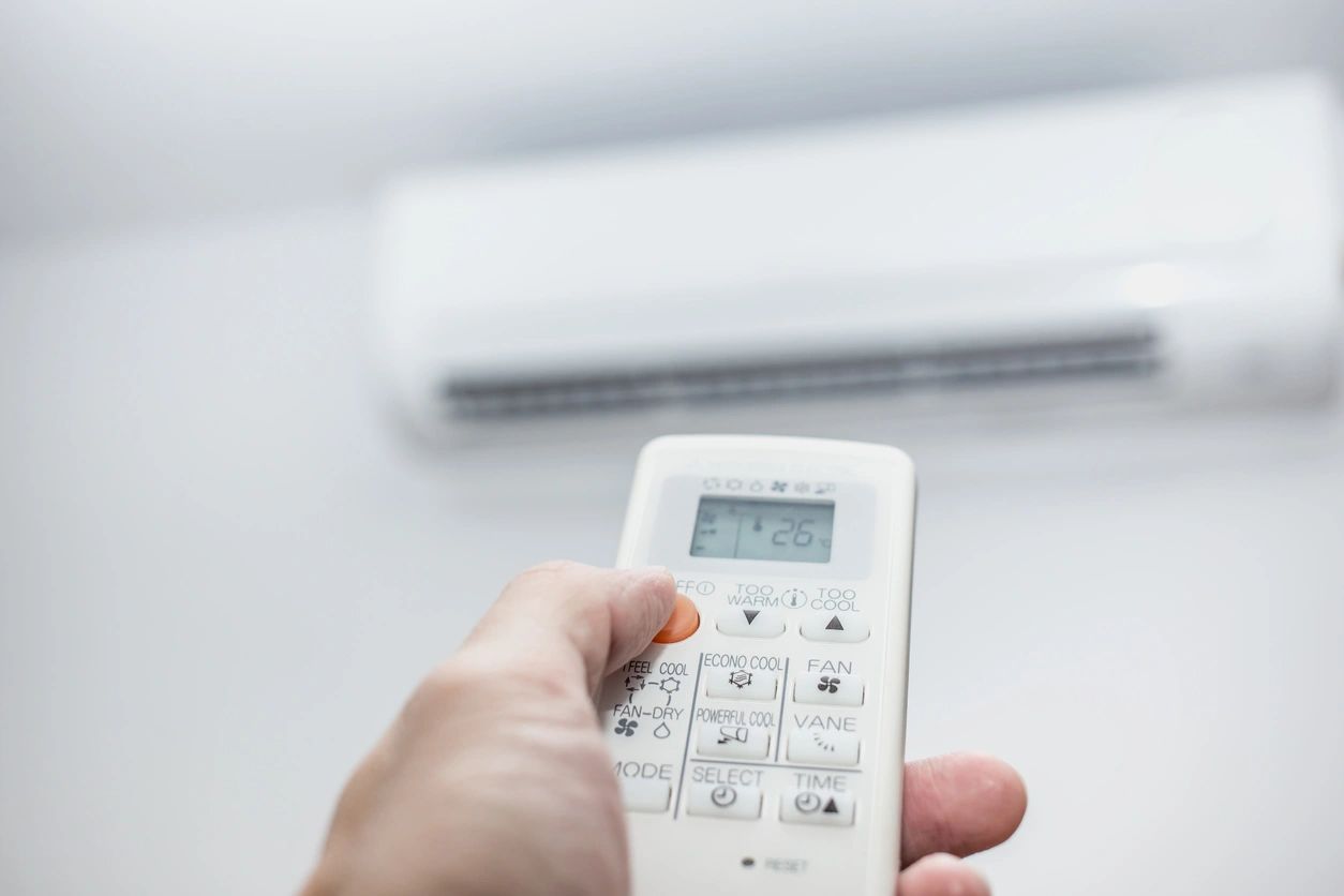 Hand holding air conditioner remote control